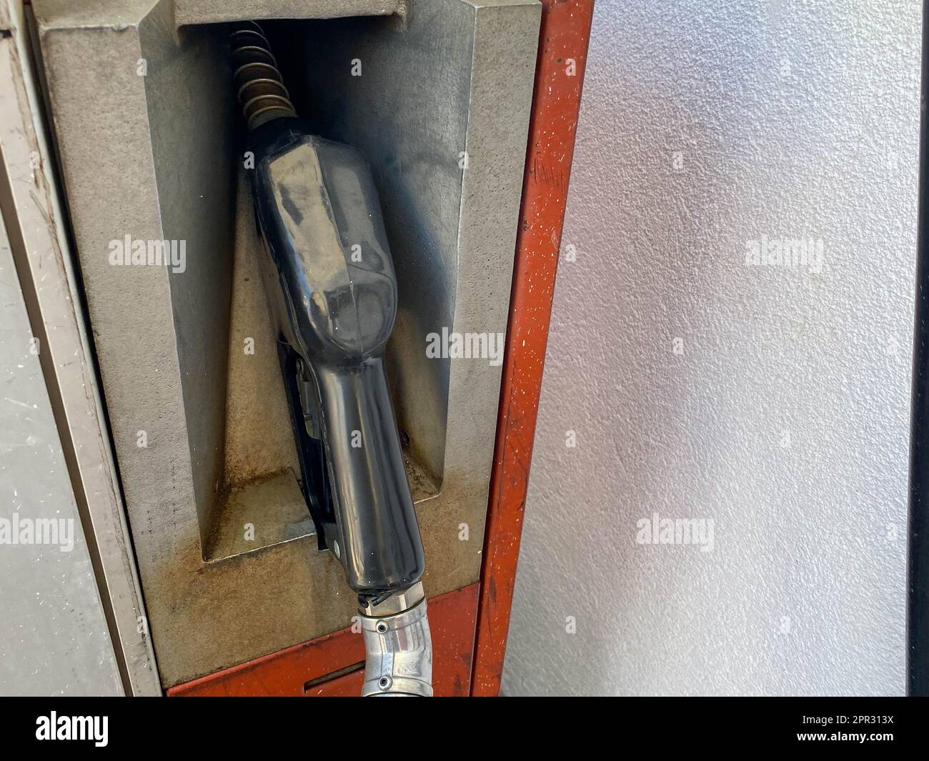 Filling colorful guns at a gas station for refueling a car with fuel, gasoline, diesel. Stock Photo