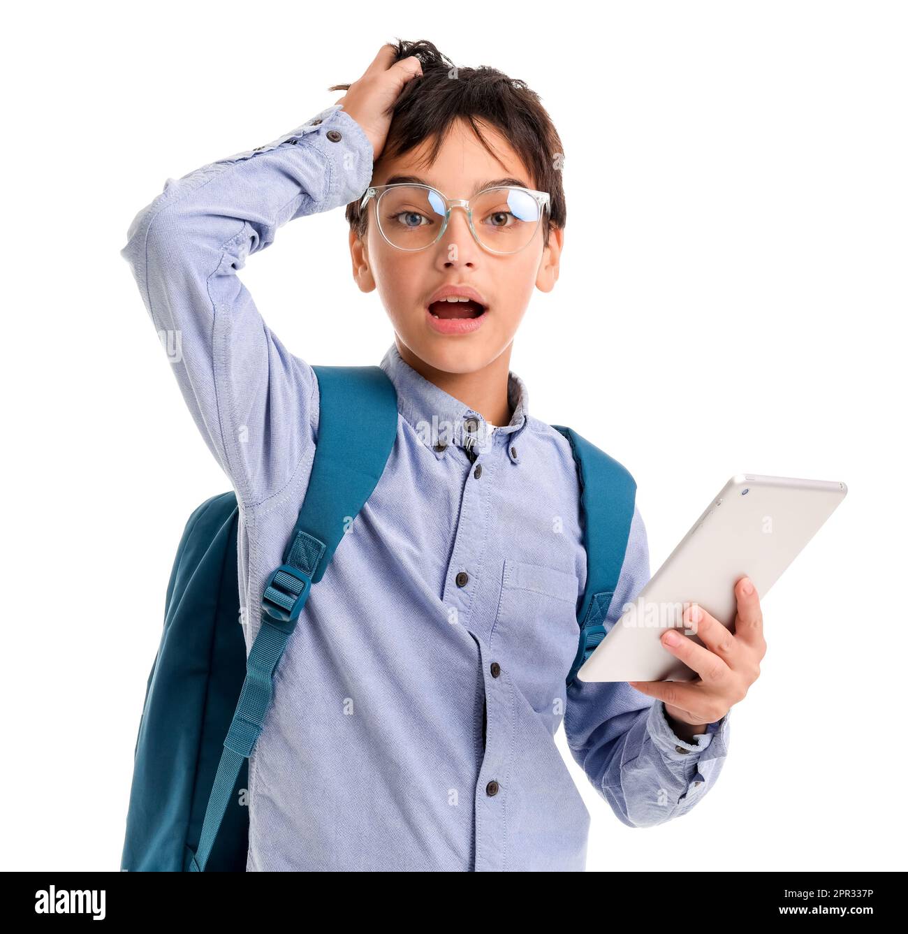 Stressed little schoolboy using tablet computer on white background ...