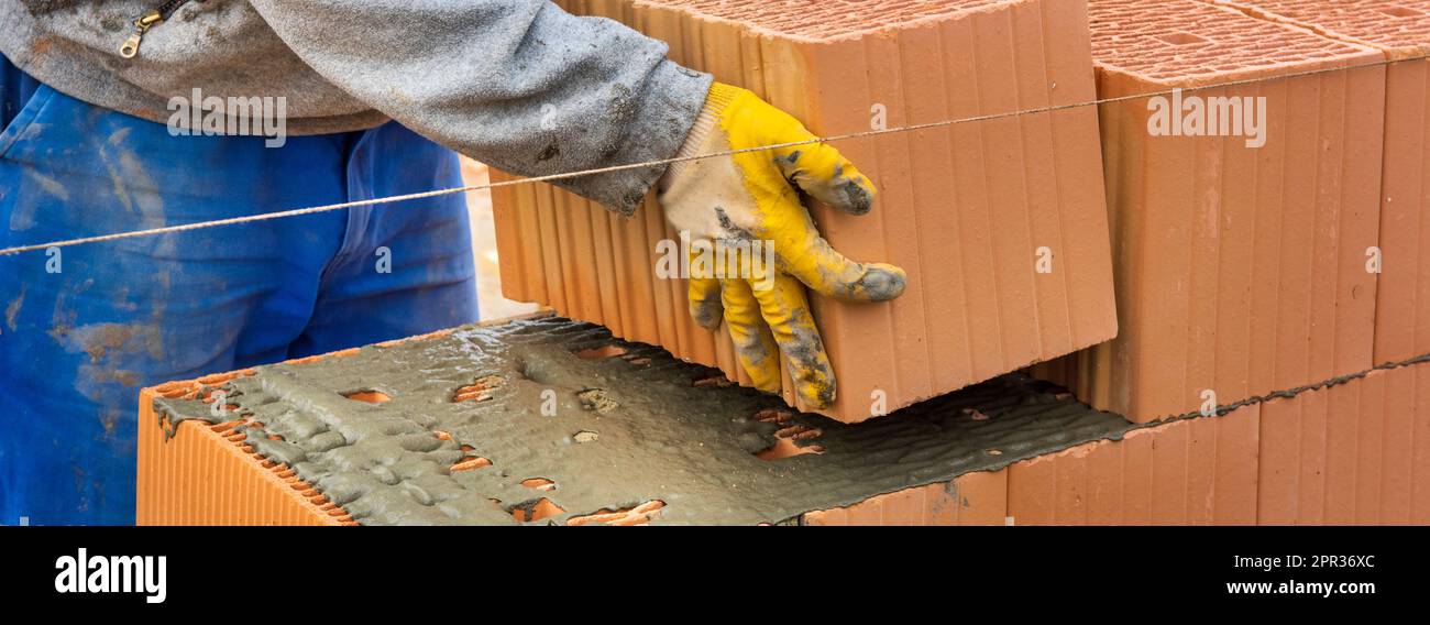 bricklayer at work at new house in construction Stock Photo