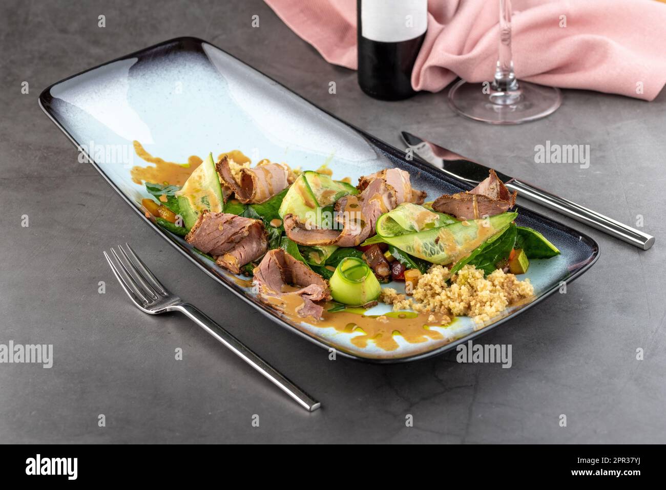 Pastrami salad on stone table in fine dining restaurant Stock Photo
