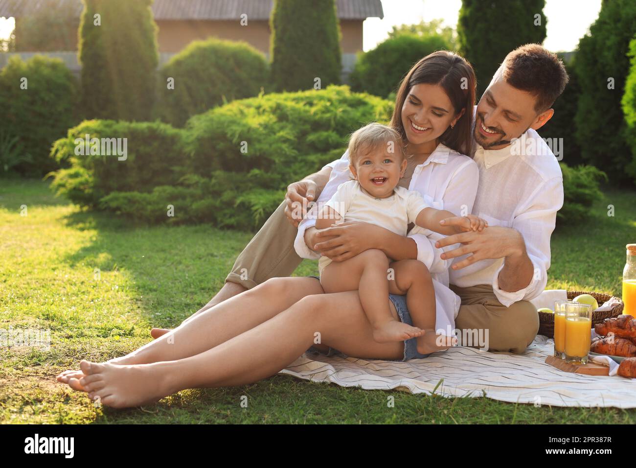 Happy family having picnic in garden on sunny day Stock Photo - Alamy