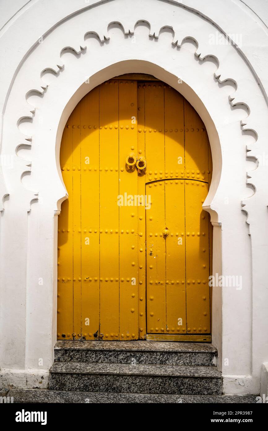 Yellow entrance door to an old house in the medina of Tangier. Stock Photo