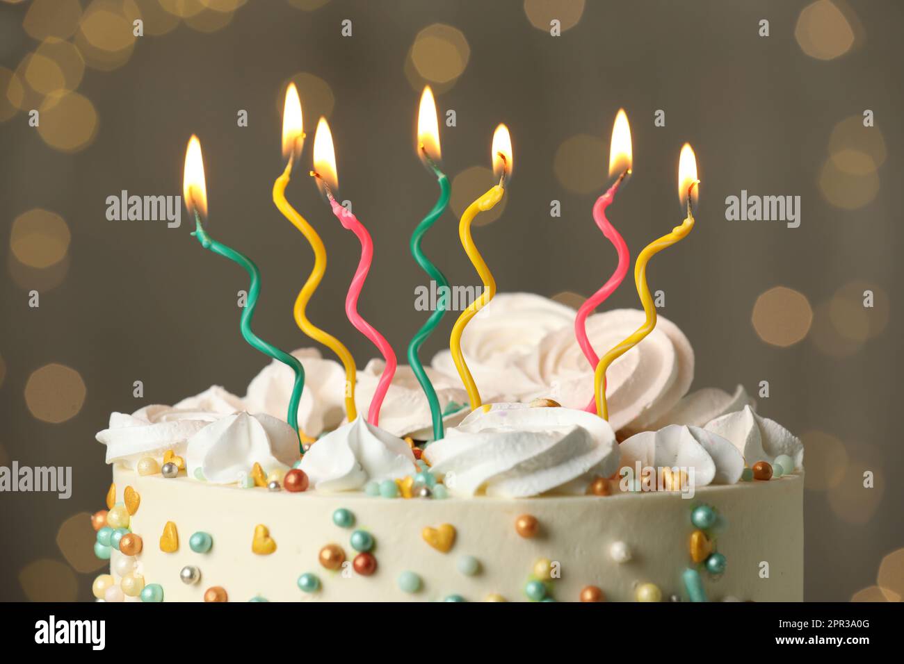 Beautiful birthday cake with burning candles on blurred background ...