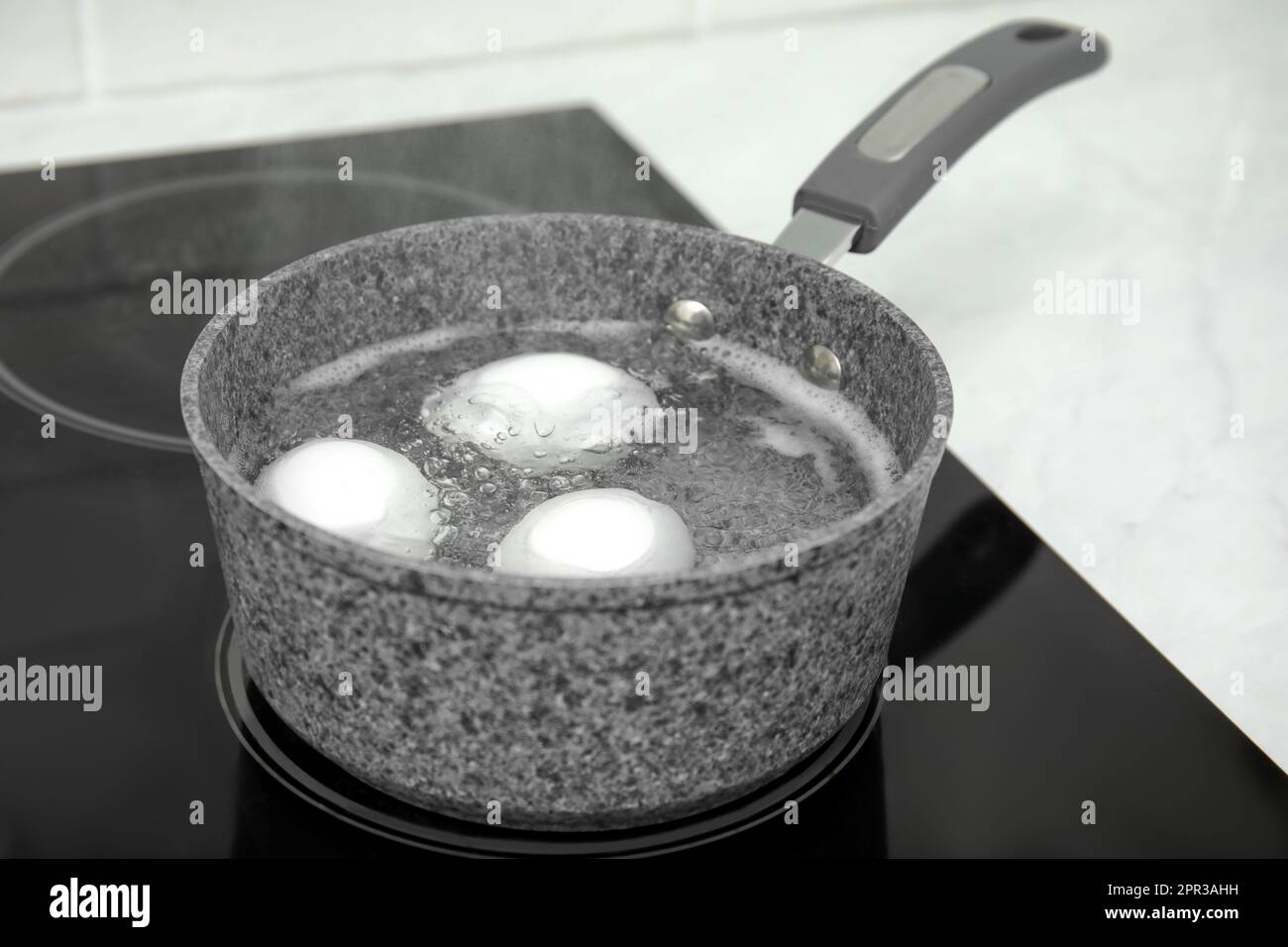 Boiling chicken eggs in saucepan on electric stove Stock Photo Alamy