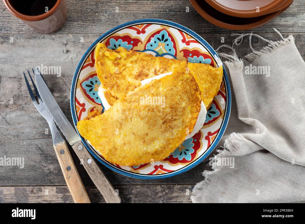 Traditional Venezuelan beef cachapa on wooden table Stock Photo