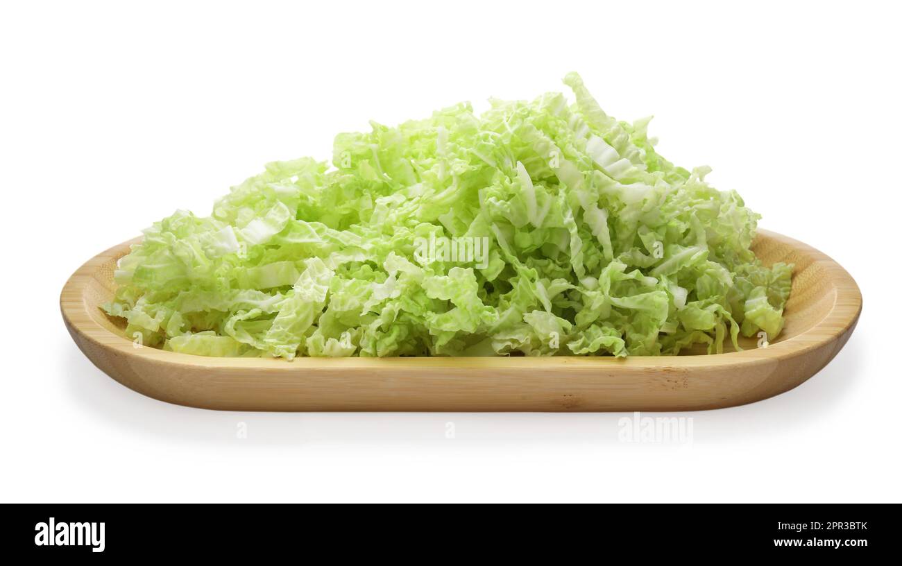 Wooden board with pile of chopped Chinese cabbage on white background ...