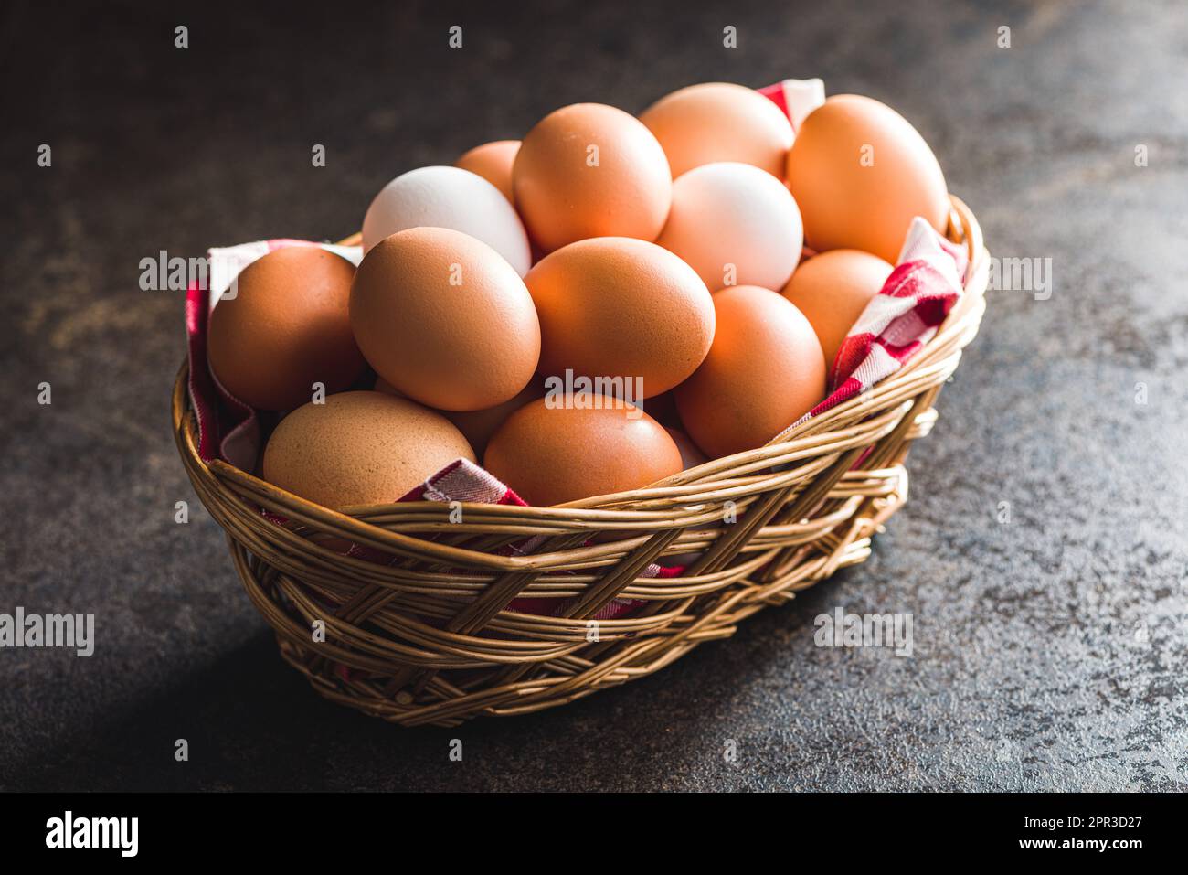 Whole chicken eggs in basket on the black table Stock Photo - Alamy