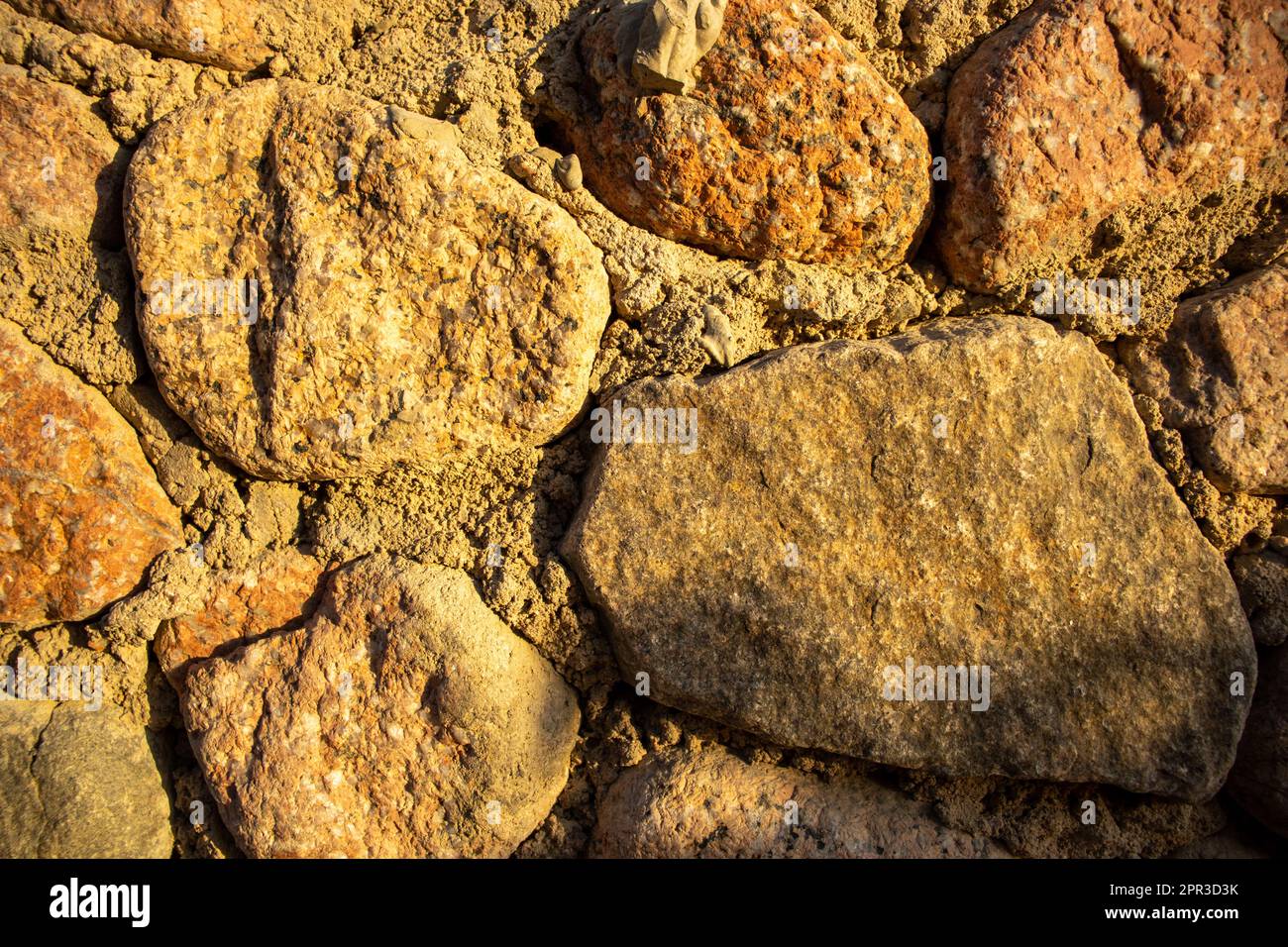 rocks and cement making a wall texture Stock Photo Alamy