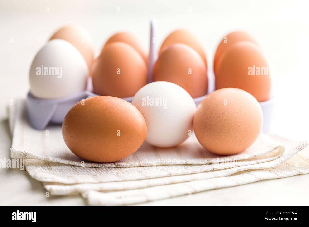 Whole chicken eggs on the kitchen napkin. Stock Photo