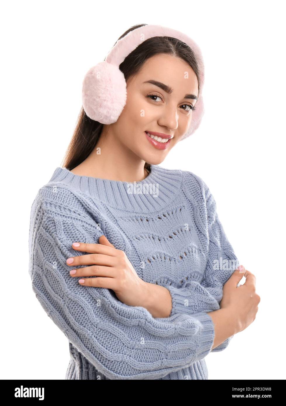 Beautiful young woman wearing earmuffs on white background Stock Photo