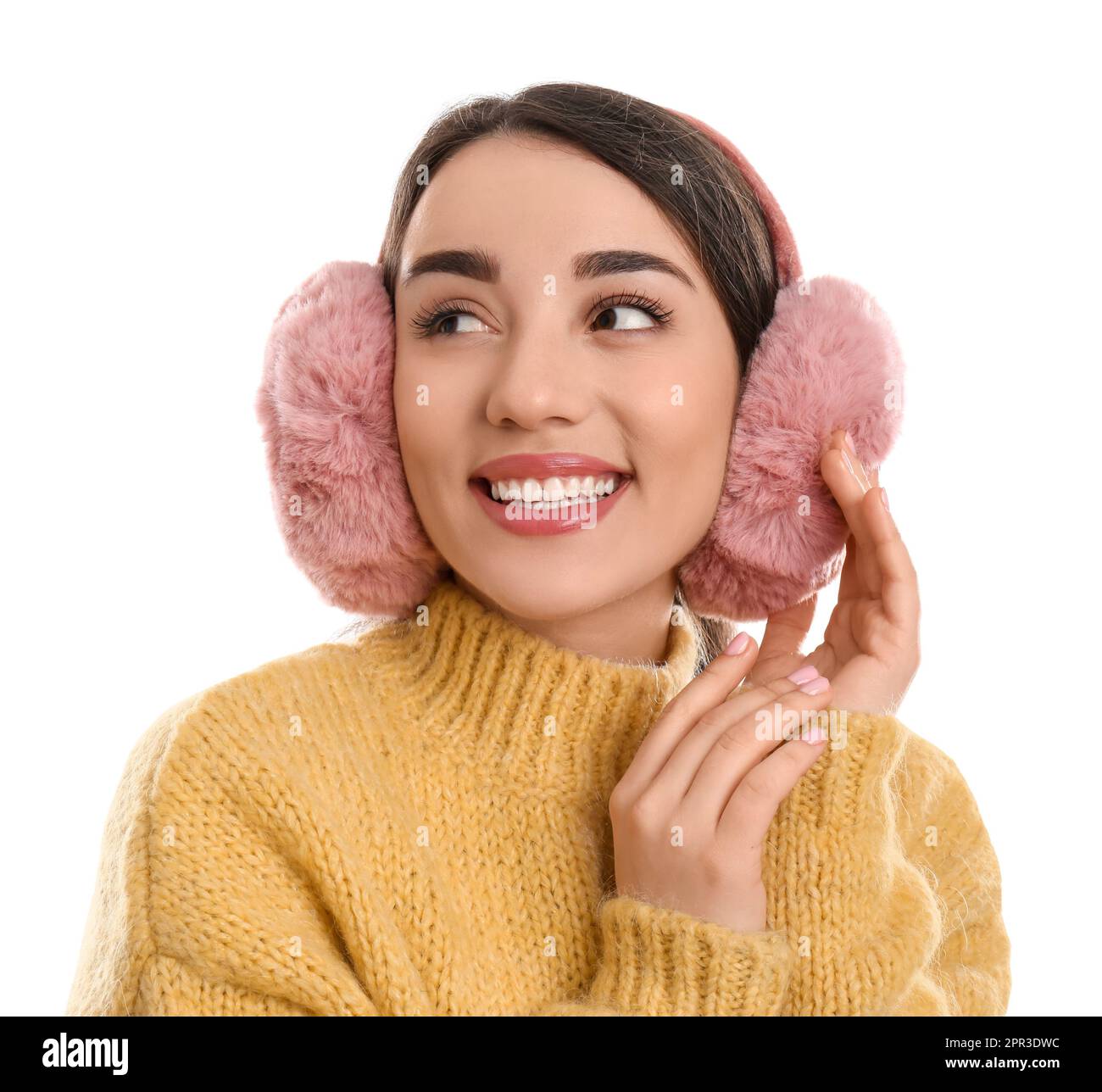 Beautiful young woman wearing earmuffs on white background Stock Photo