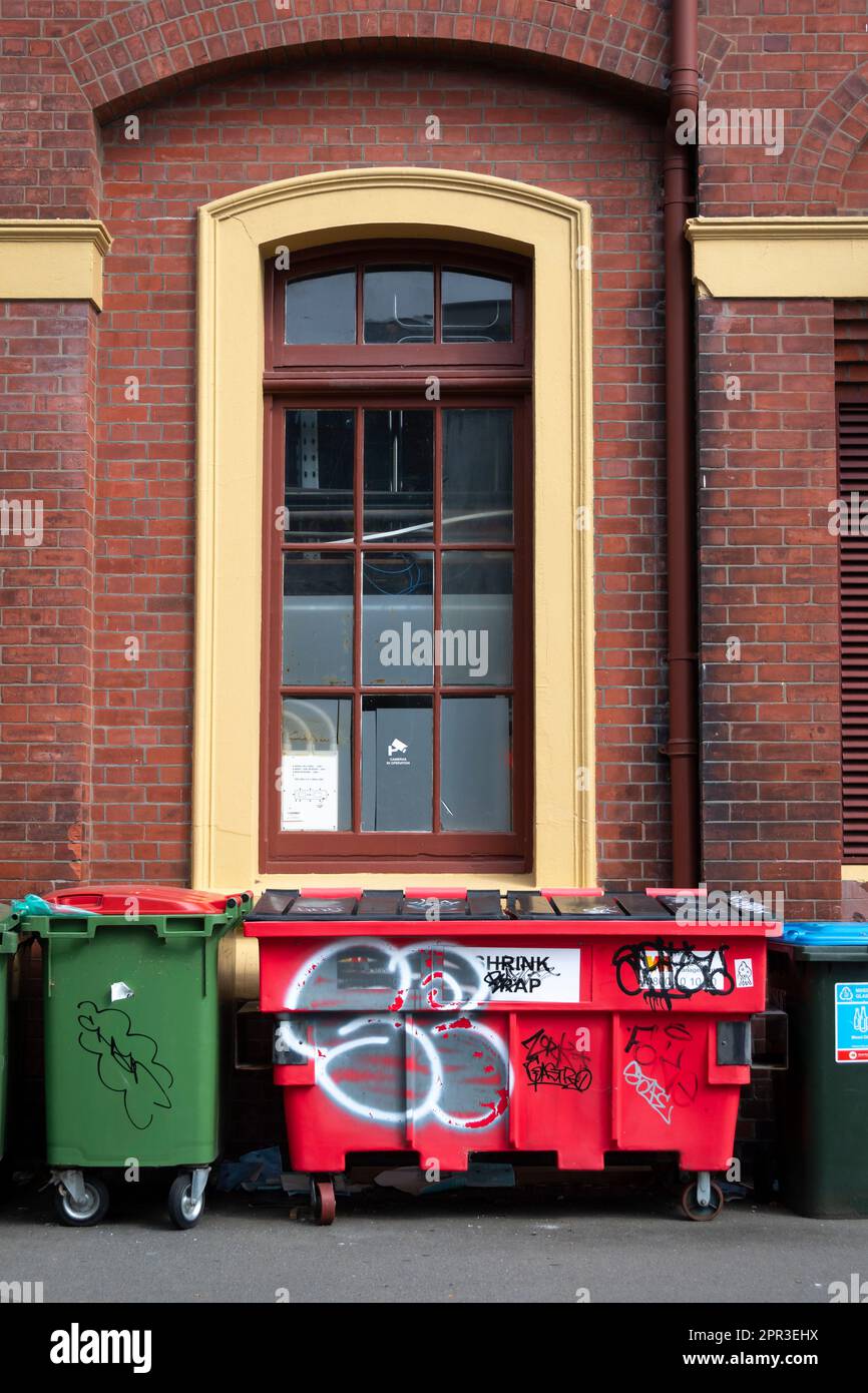 Waste bins beside brick wall, Wellington, North Island, New Zealand