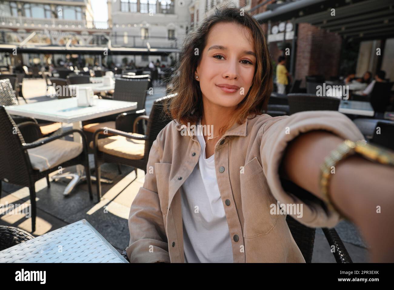 Happy young woman taking selfie in outdoor cafe Stock Photo - Alamy