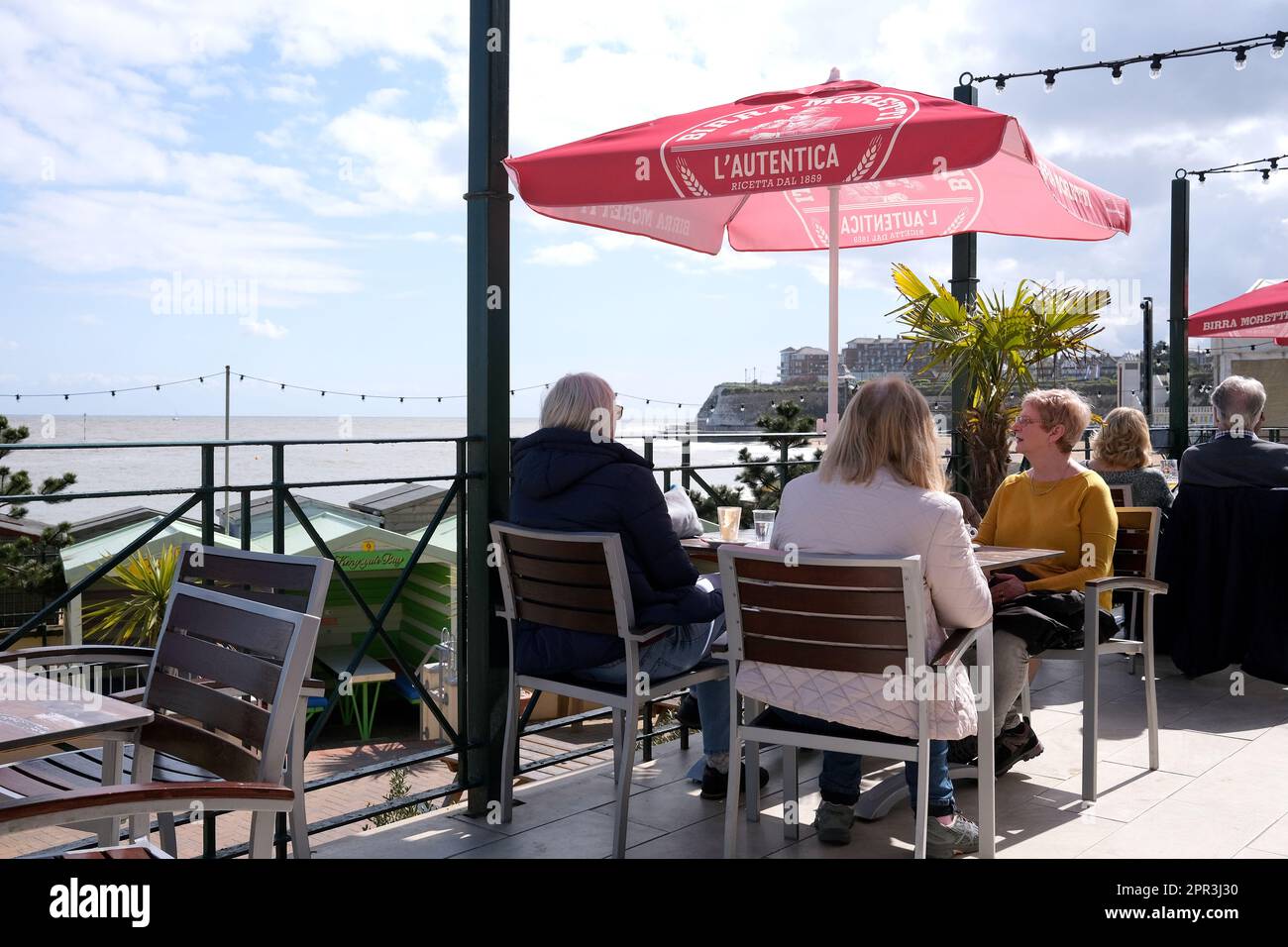 people seated in a coffee bar relaxing,broadstairs town,isle of thanet,east kent,uk april 2023 Stock Photo