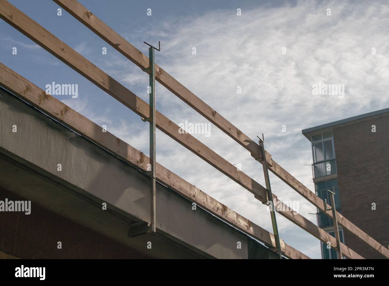 fall arrest scaffolding on a construction site. roof with wooden