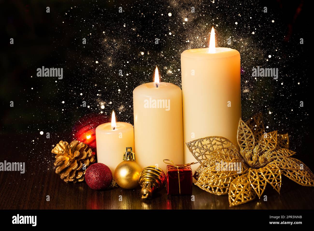 Christmas holiday card with  three burning candles and ornaments. Christmas decoration with candles over dark background with bokeh light. Christmas b Stock Photo