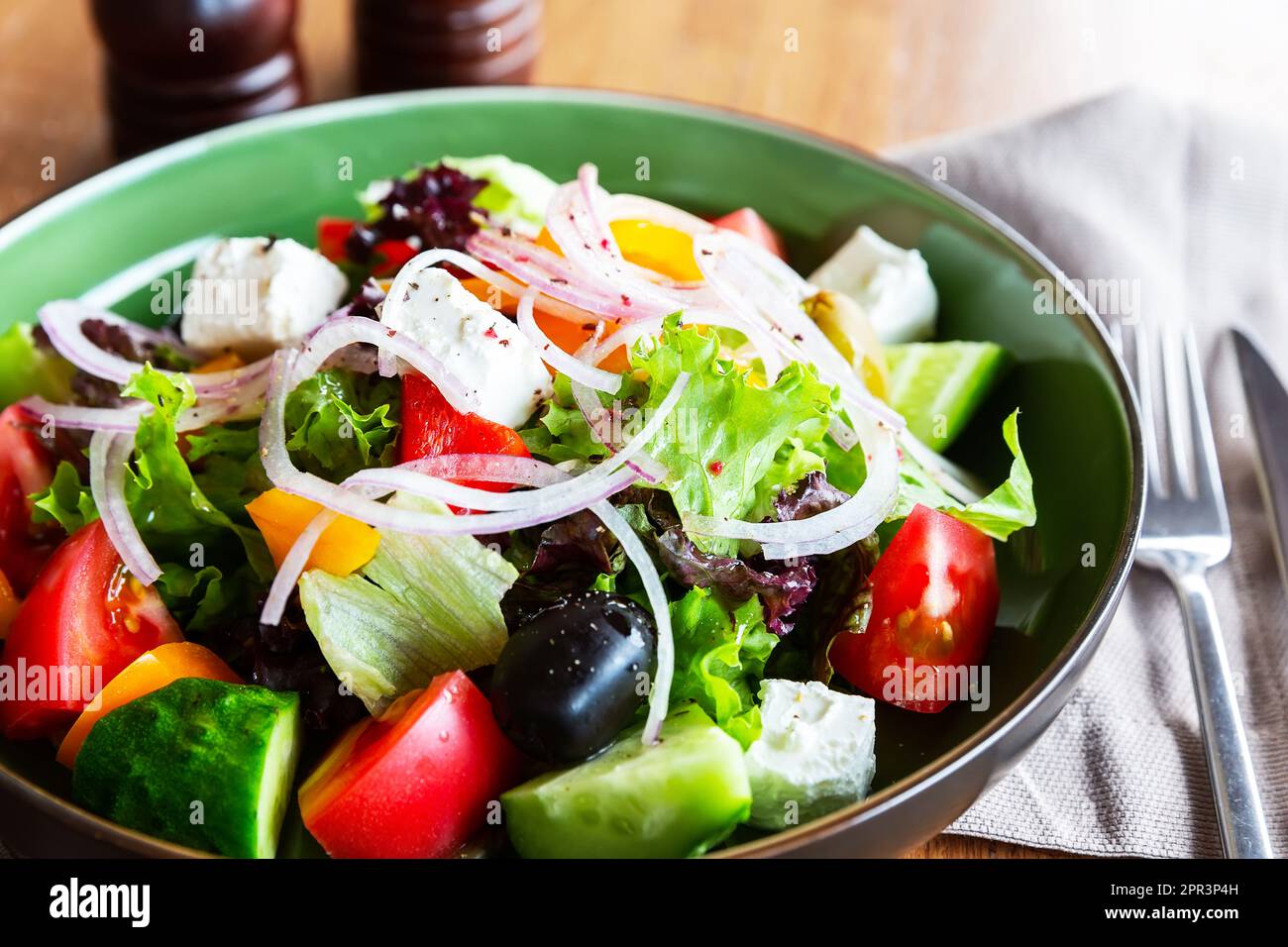 Fresh greek salad with tomato, cucumber, bell pepper, onion and feta