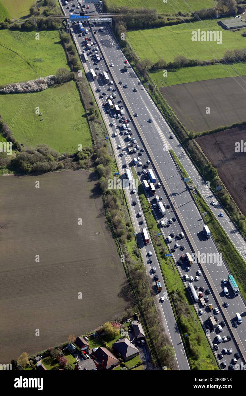 aerial view looking east across the M1 motorway with heavy traffic just north of junction 41 at Carr Gate near Wakefield, West Yorkshire Stock Photo