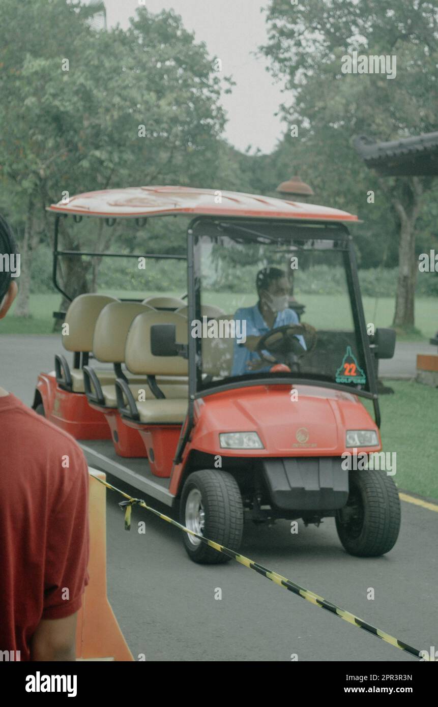 person riding a golf car Stock Photo