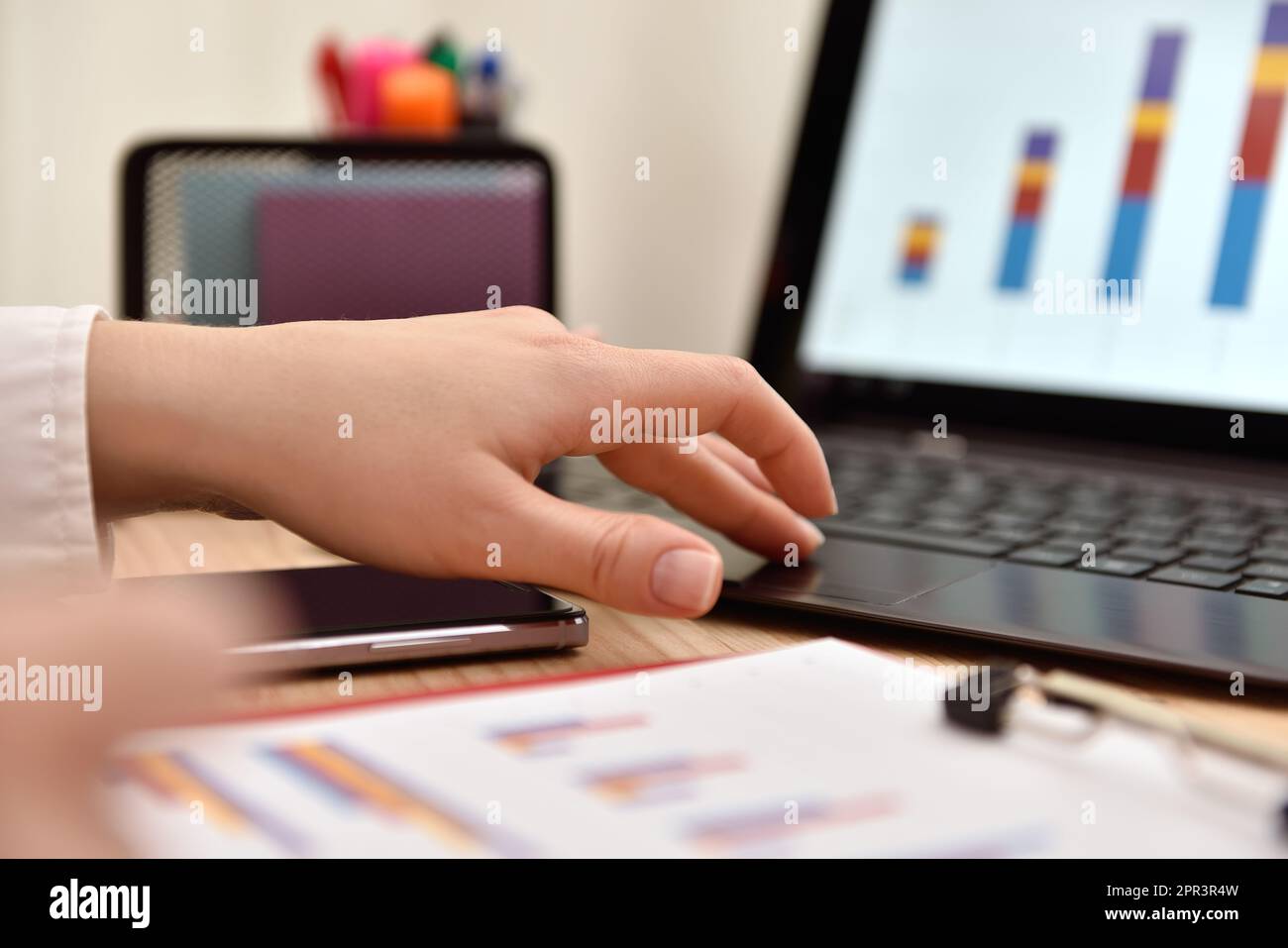 Trader hand analyzing income charts and graphs with laptop computer on ...