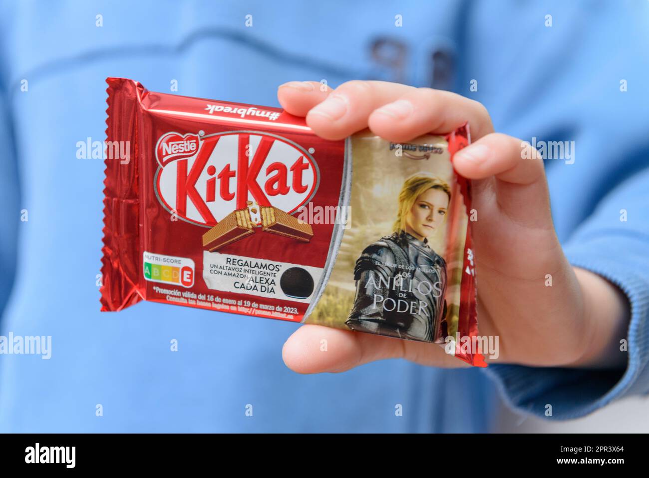 Arahal. Seville. Spain. March 18, 2023. Closeup of a child's hands holding a candy bar from the brand Nestle KitKat. Excessive consumption of sugar ca Stock Photo