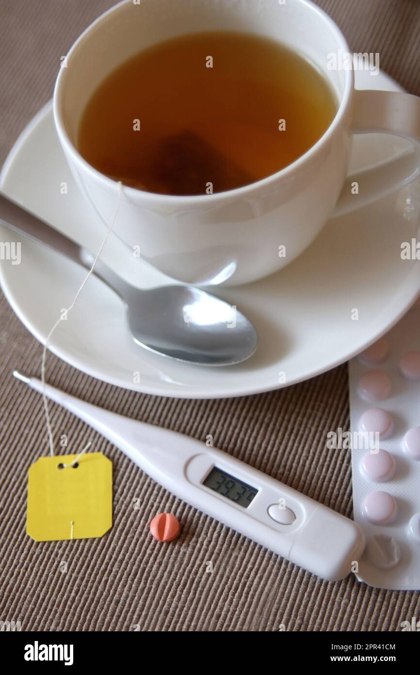 tea for cold with thermometer and tablets Stock Photo - Alamy