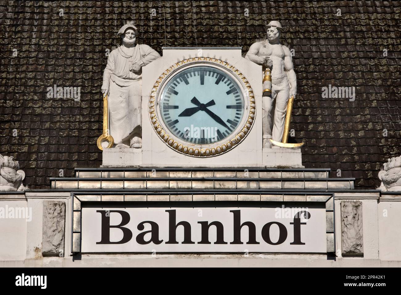 ironworks man and miner at the station clock of main station Hamm, Germany, North Rhine-Westphalia, Ruhr Area, Hamm Stock Photo