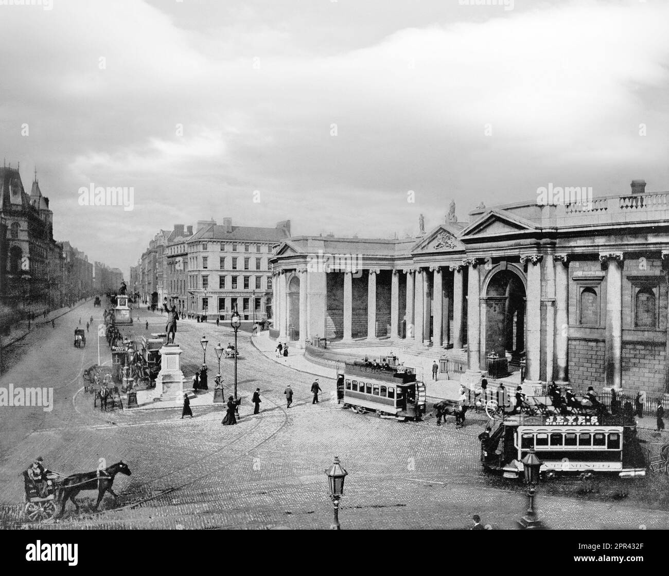 A late 19th century photograph of College Green in the centre of Dublin, Ireland. On its northern side is the Bank of Ireland building, which until 1800 was Ireland's Parliament House. It was originally constructed by Arthur Chichester, 1st Baron Chichester in the early 17th century and later adapted for the Irish Parliament around 1670. It was replaced by a new Parliament House in 1729, designed by Edward Lovett Pearce, it was later enlarged by James Gandon in 1787 and Edward Parke between 1804 and 1808. The site is now the Bank of Ireland. Stock Photo