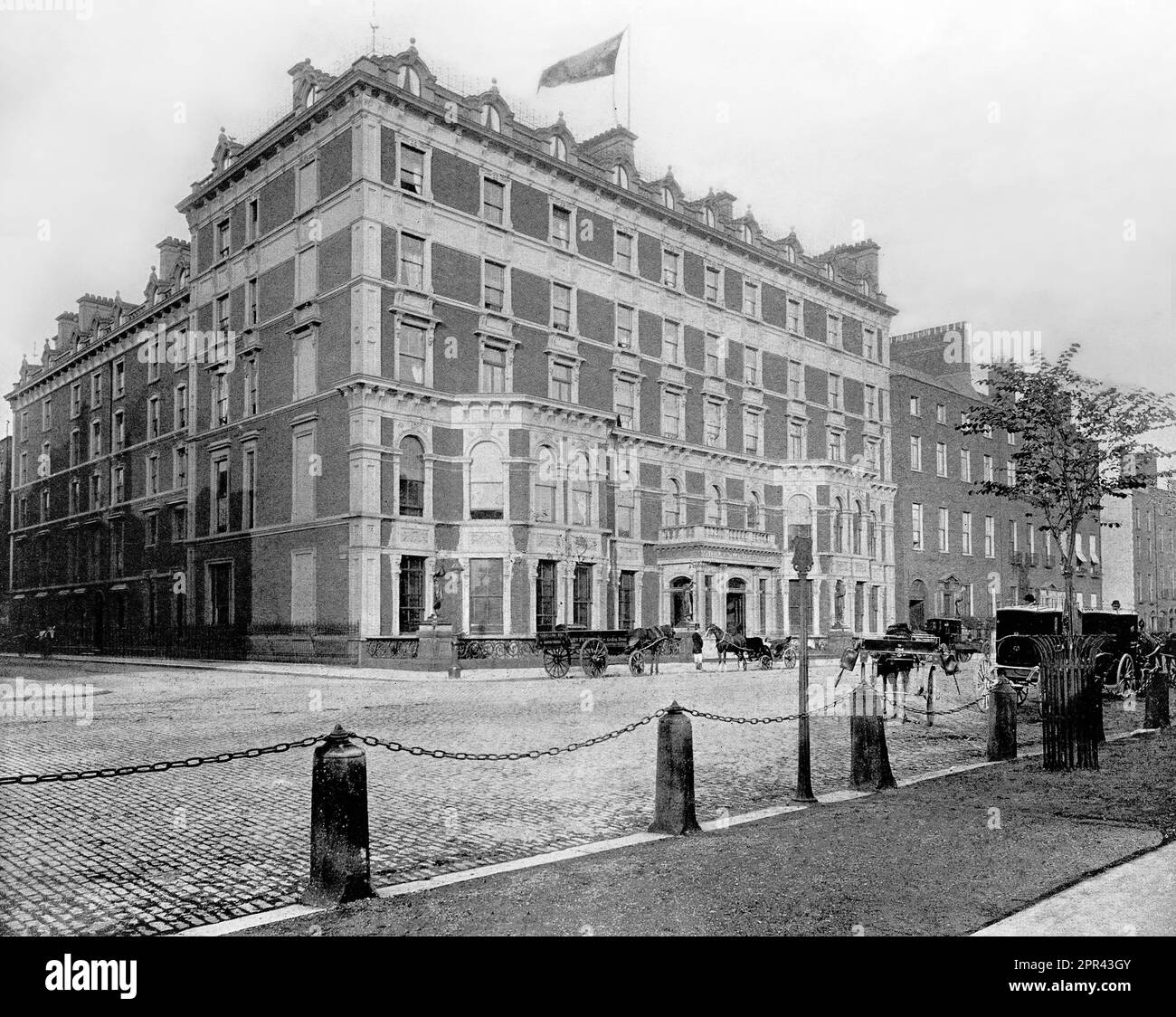 A late 19th century view of the Shelbourne Hotel, a historic hotel on the north side of St Stephen's Green in Dublin, Ireland. The hotel was founded in 1824 by Martin Burke, a native of Tipperary, when he acquired three adjoining townhouses overlooking Stephen's Green, Europe's largest garden square. Burke named his grand new hotel The Shelbourne, after William Petty, 2nd Earl of Shelburne. Stock Photo