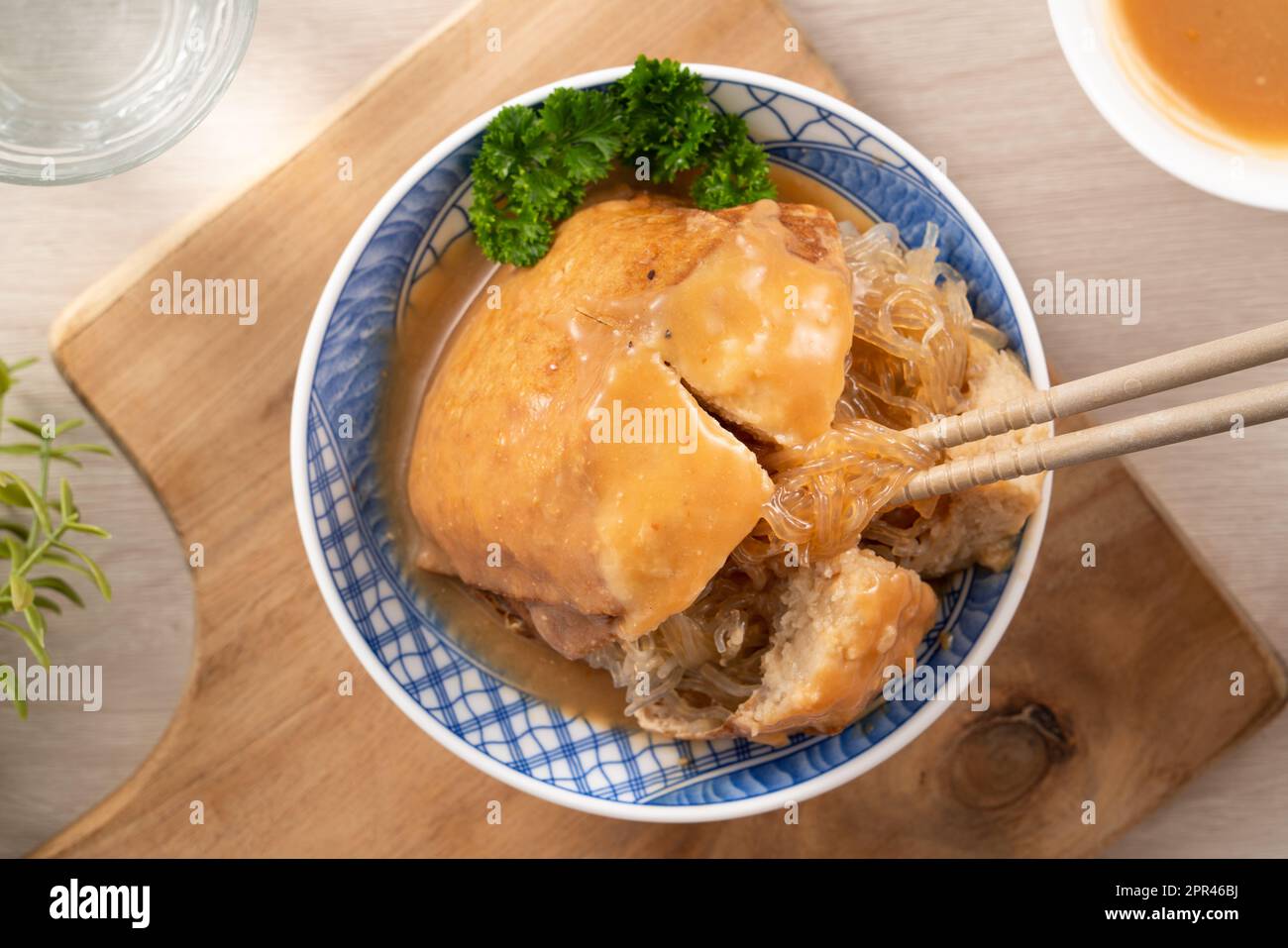 Tamsui agei (age, aburaage, ageh), delicious street food in Taiwan, stuffed with mung bean noodles and sauce topping. Stock Photo