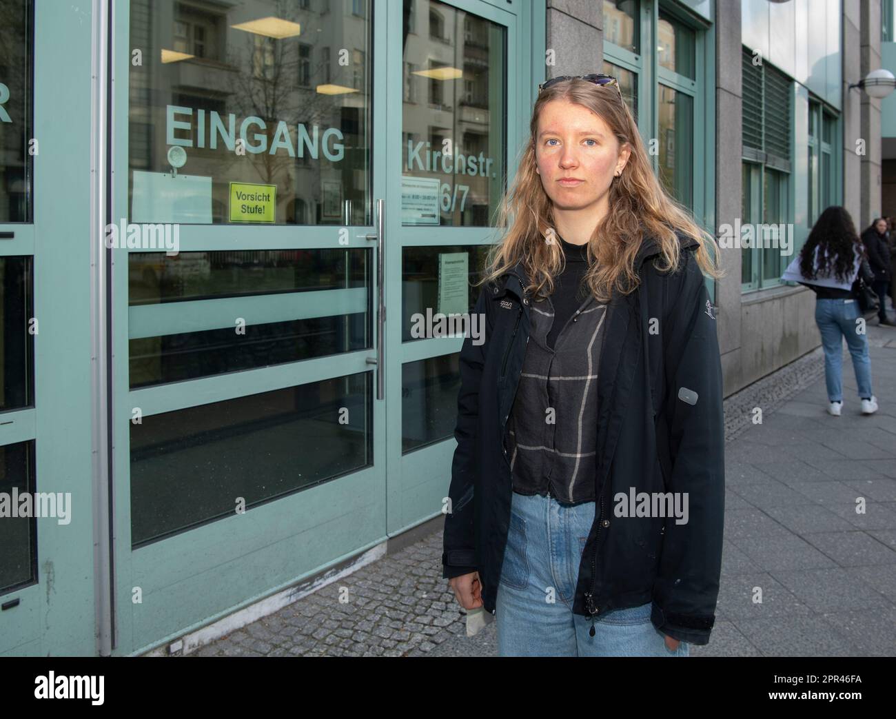 Berlin, Germany. 26th Apr, 2023. Maya, an environmental activist from the group Letzte Generation, stands in front of the building of the district court. There she has to answer for a gluing action in a Berlin museum. Credit: Paul Zinken/dpa/Alamy Live News Stock Photo
