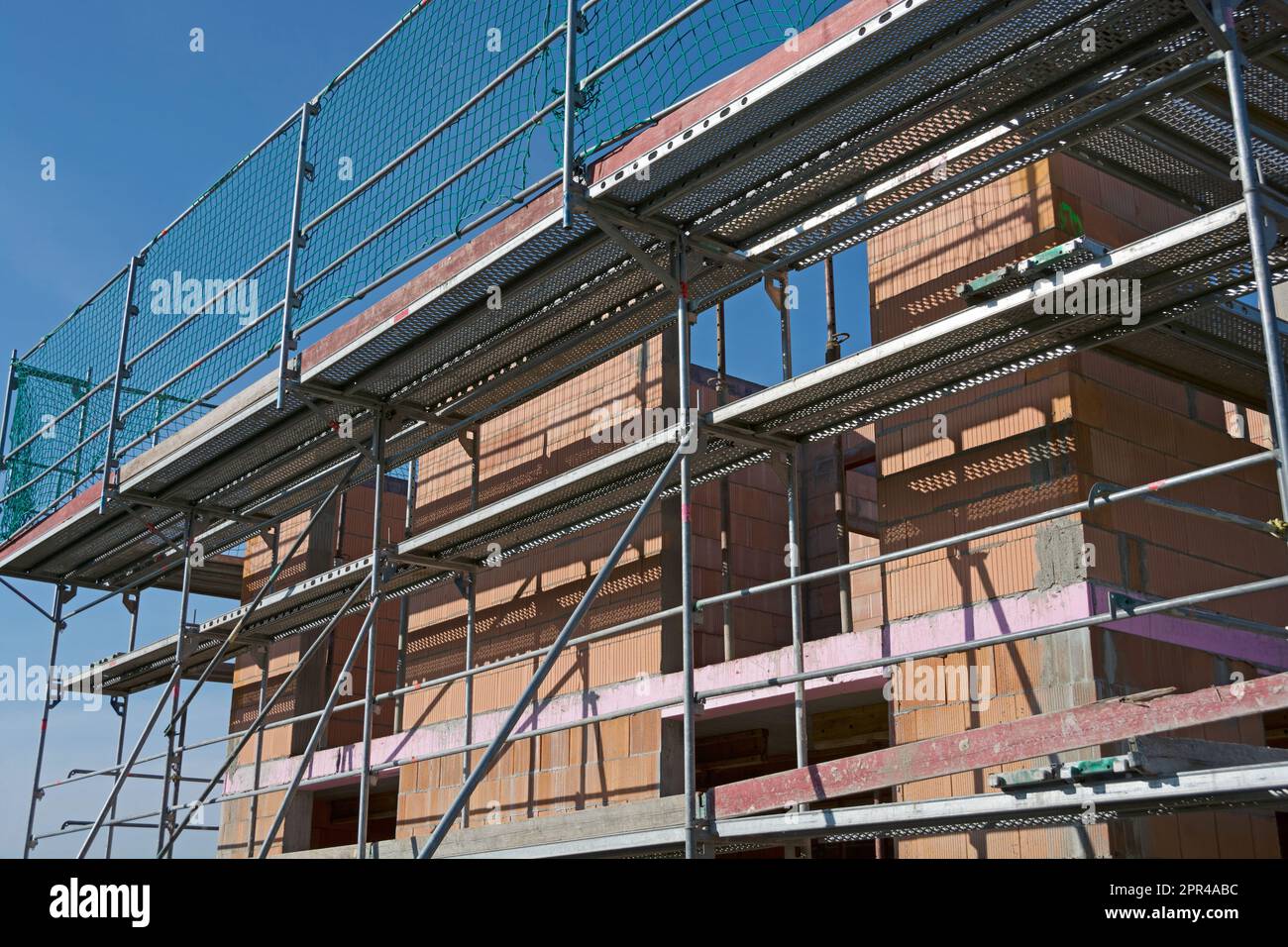 Massive home in shell construction with scaffolding Stock Photo