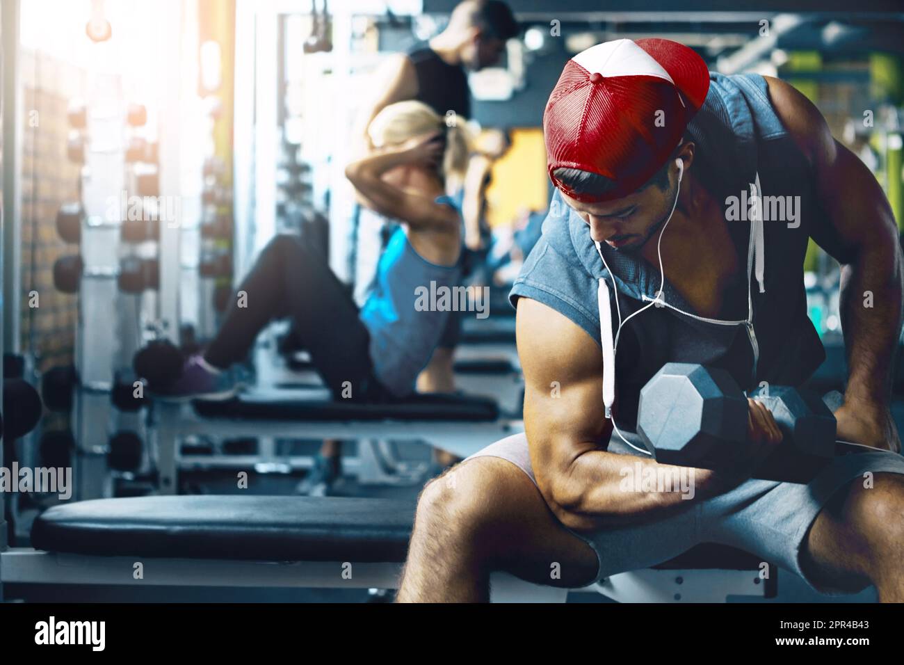 Its only difficult until its easy. a man doing weight training at the gym Stock Photo Alamy