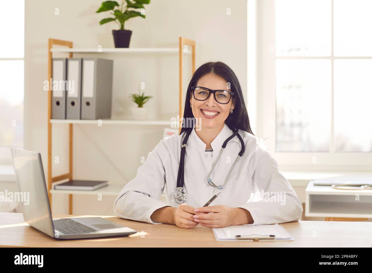 Cheerful young female doctor hi-res stock photography and images - Alamy