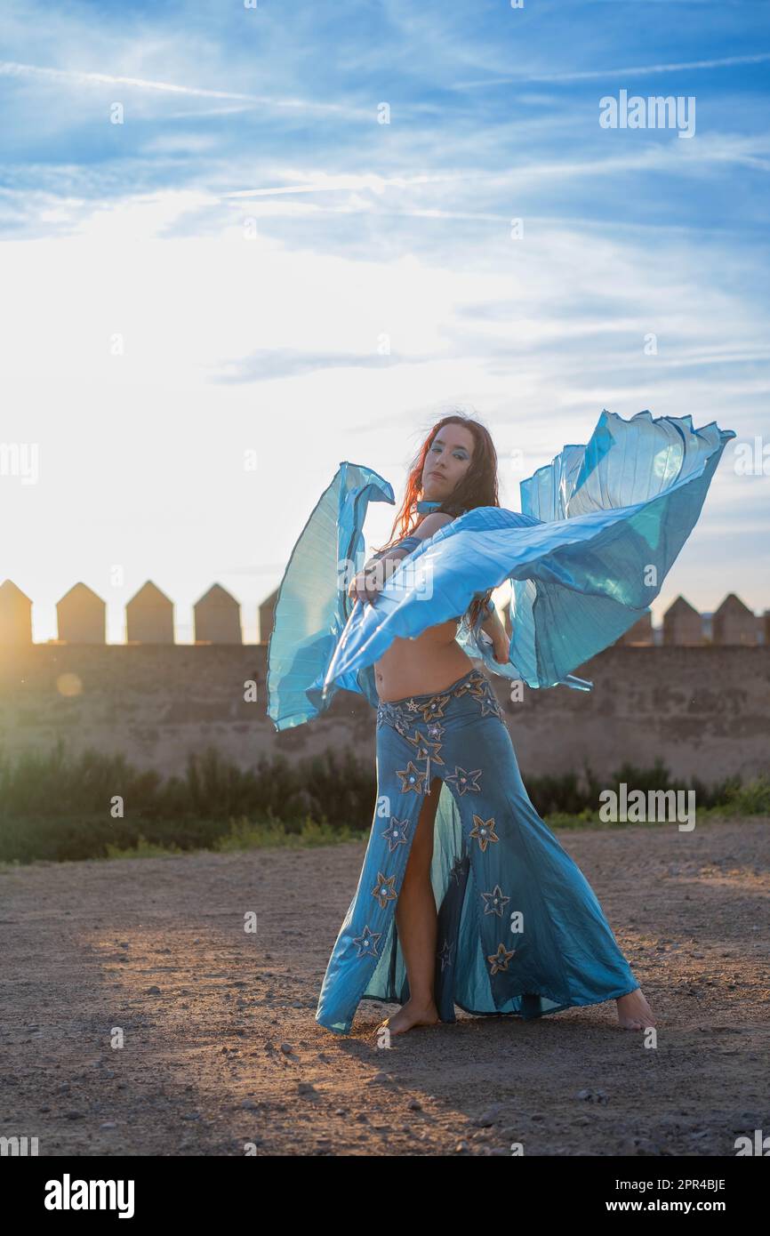 Oriental dancer dressed in blue with Isis Wings of the same color ...