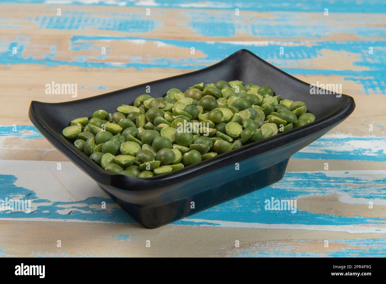 bowl with soy beans on blue rustic wooden table, Up  view Stock Photo