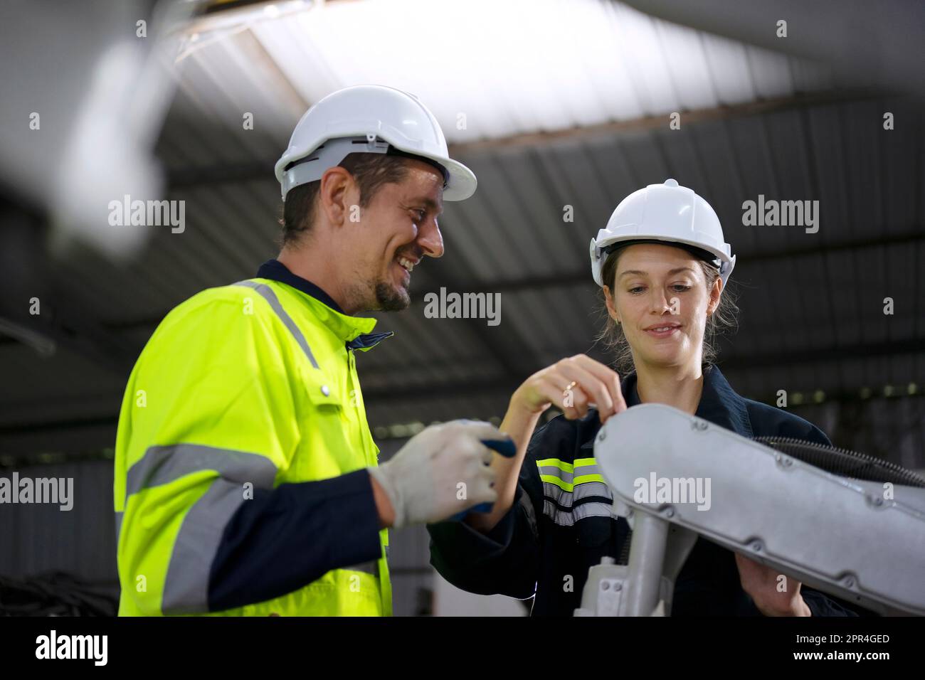 Engineer work at robotic arm factory. Technology and engineering concept. Stock Photo