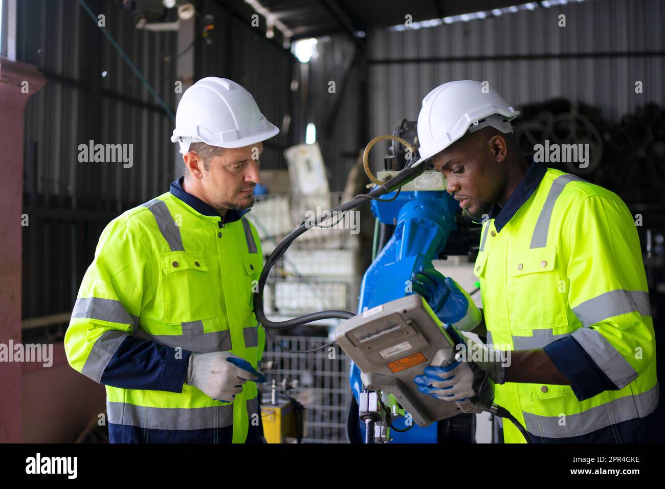 Engineer work at robotic arm factory. Technology and engineering concept. Stock Photo
