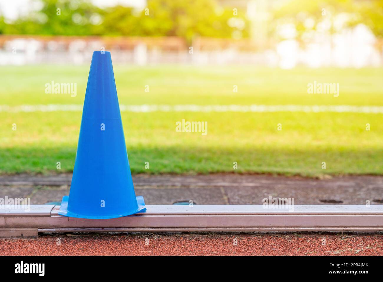 football grass field running track and training cone for sport exercise outdoors activity background Stock Photo