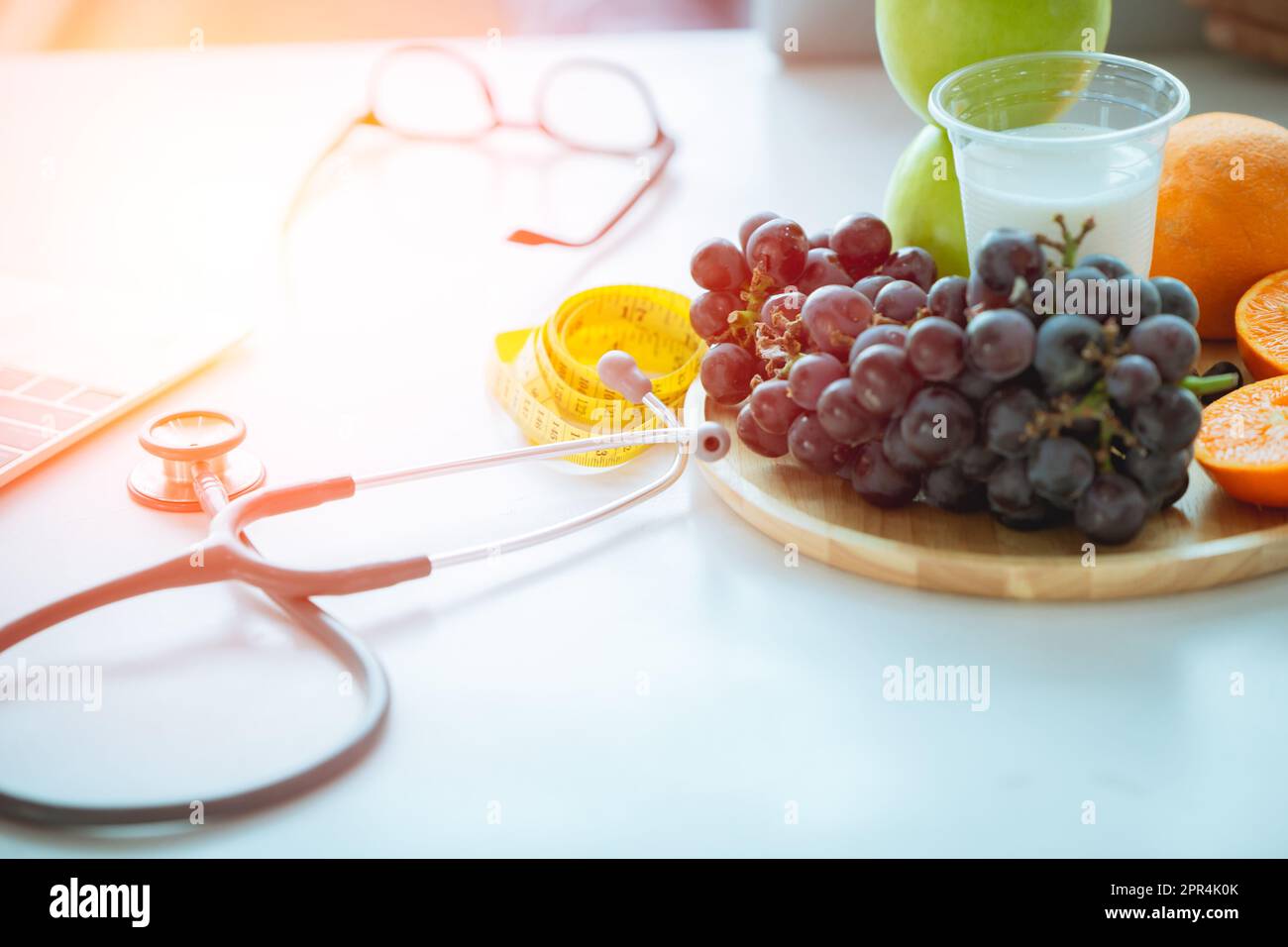 Stethoscope with fruit and milk for doctor recommend to eating healthy food concept Stock Photo