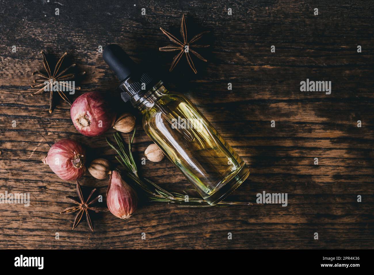 Herbal oil extract herb essences for meditation aroma on wooden background with copy space Stock Photo