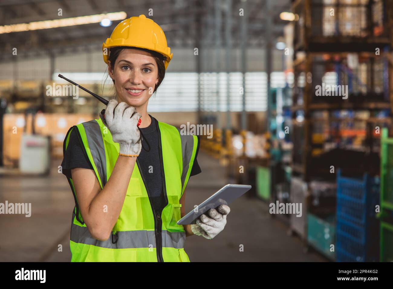 portrait working woman staff worker inventory management supervisor team work operate warehouse products shipping control job. Stock Photo