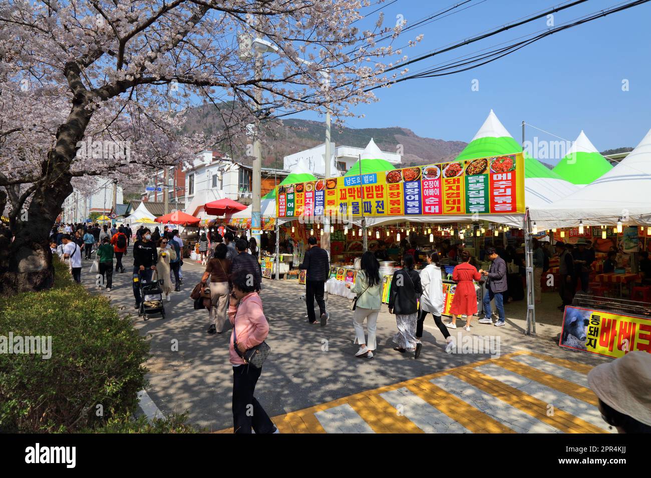 JINHAE, SOUTH KOREA - MARCH 28, 2023: People visit food stands at