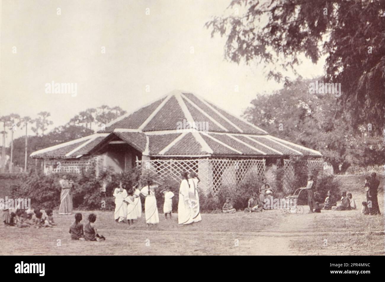 The Cottage Nursery. In the Dohnavur compound. Half-tone engraving from a photograph by Mr. Penn of Ootacamund (now known as Ooto), in the Tamil Nadu region of Southern India, c1912. The image relates to the Church of England Zenana Mission’s nursery and compound in Dohnavur, also in Tamil Nadu and about thirty miles from the southern tip of India. The compound was run by Amy Wilson-Carmichael and sought to promote Christianity among babies and children (at the time only girls, many who were victims of temple prostitution). Stock Photo