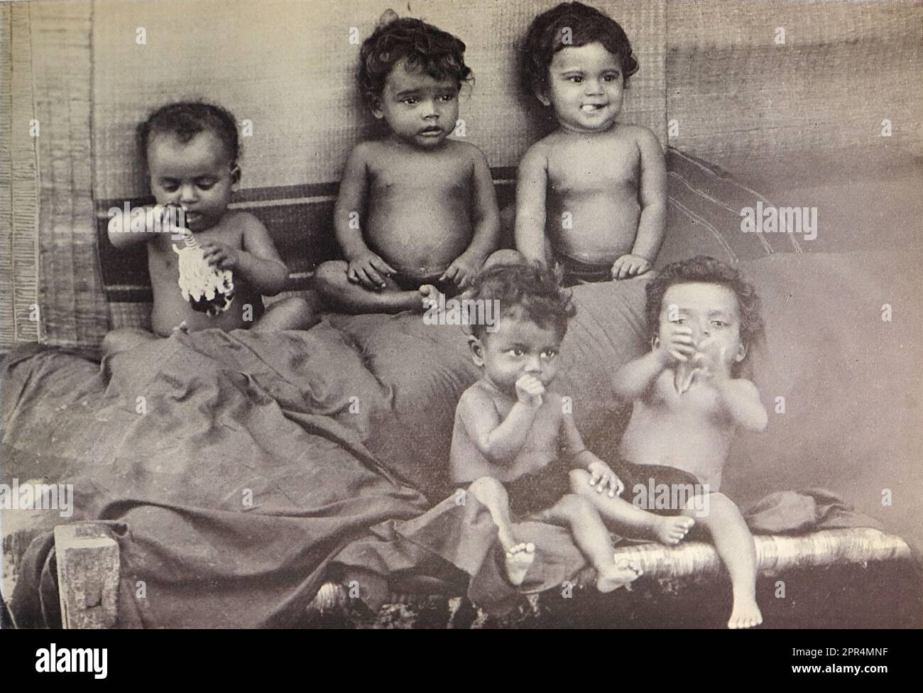 A group of five young children. In the Dohnavur compound. Half-tone engraving from a photograph by Mr. Penn of Ootacamund (now known as Ooto), in the Tamil Nadu region of Southern India, c1912. The image relates to the Church of England Zenana Mission’s nursery and compound in Dohnavur, also in Tamil Nadu and about thirty miles from the southern tip of India. The compound was run by Amy Wilson-Carmichael and sought to promote Christianity among babies and children (at the time only girls, many who were victims of temple prostitution). Stock Photo
