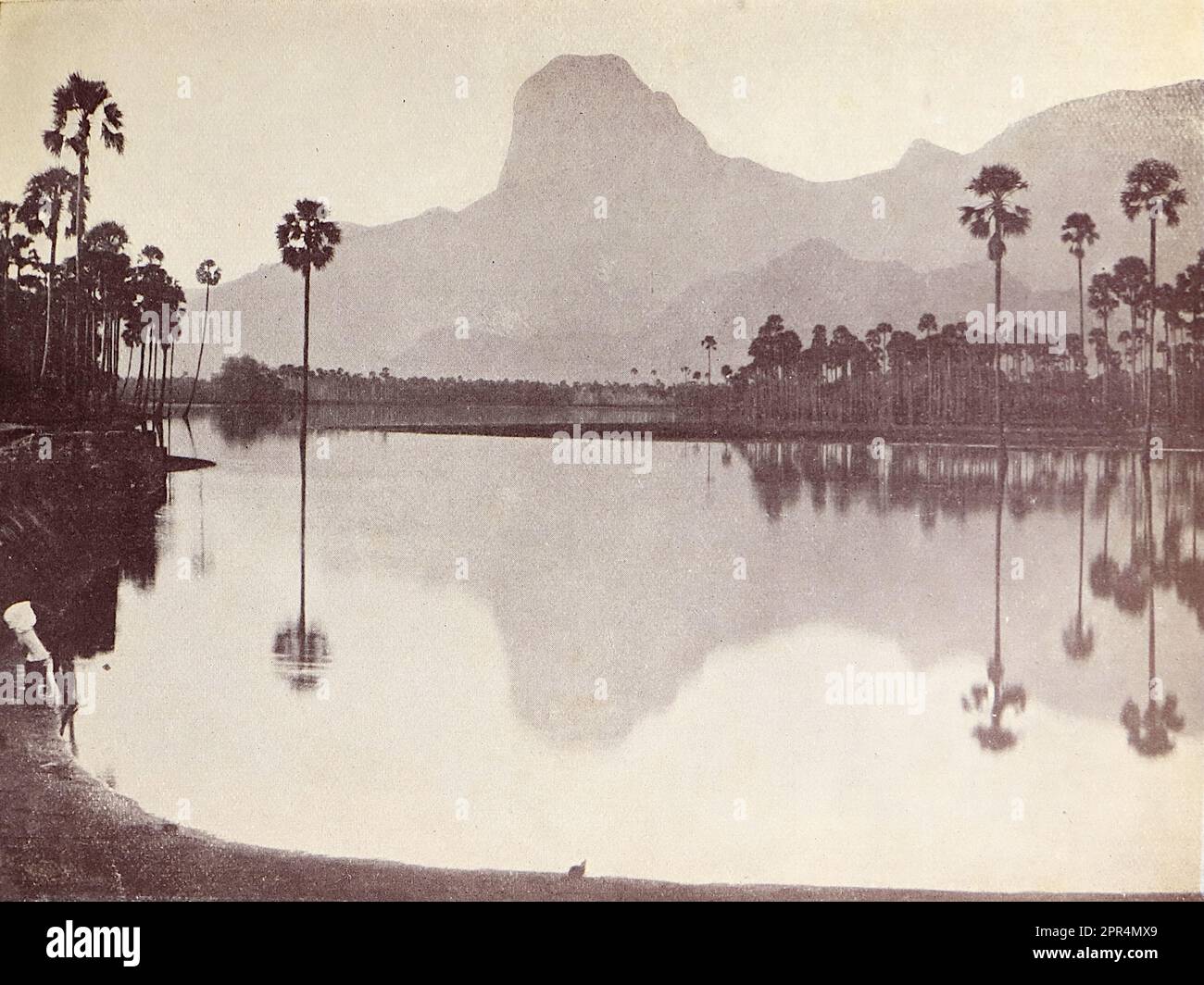 The Red Lake and hill, as seen from the Taraha nursery. Half-tone engraving from a photograph by Mr. Penn of Ootacamund (now known as Ooto), in the Tamil Nadu region of Southern India, c1912. The image relates to the Church of England Zenana Mission’s nursery and compound in Dohnavur, also in Tamil Nadu and about thirty miles from the southern tip of India. The compound was run by Amy Wilson-Carmichael and sought to promote Christianity among babies and children (at the time only girls, many who were victims of temple prostitution). Stock Photo