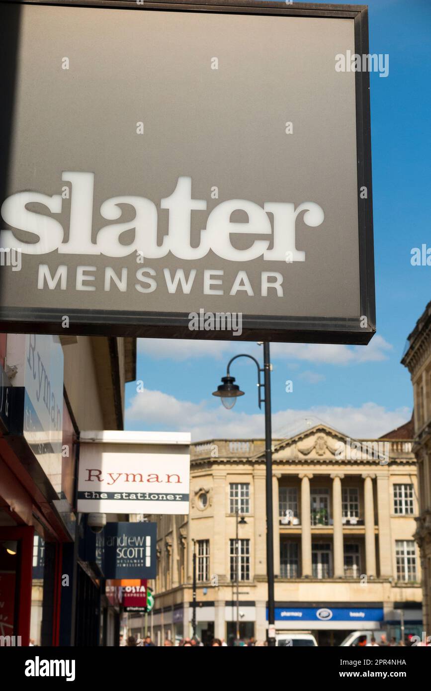 Collection of Shopfront signs including Slater menswear in a row of retail outlets / store sign on a shop front facade / retail outlet entrance in busy high street town centre shopping area. Cheltenham Spa. Gloucestershire. UK. (134) Stock Photo