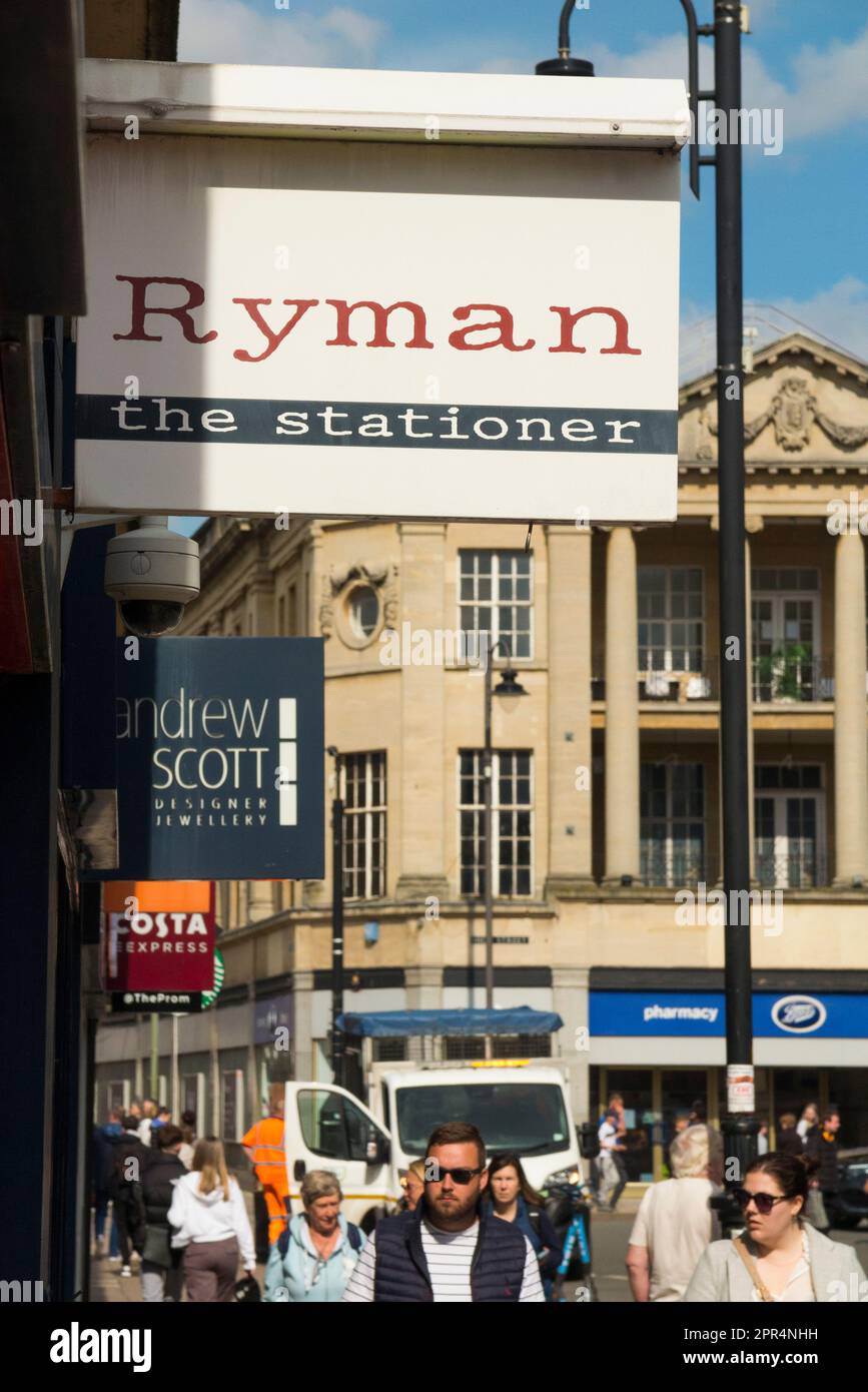 Collection of Shopfront signs including for Ryman the Stationer in a row of retail outlets / store sign on a shop front facade / retail outlet entrance in busy high street town centre shopping area. Cheltenham Spa. Gloucestershire. UK. (134) Stock Photo