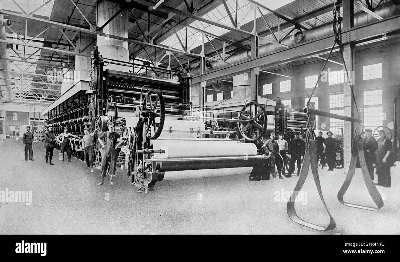 Paper making machine. The early twentieth century is recalled as the age of mechanisation. This was a time when man further developed the progress of the industrial revolution and learned to adapt the forces of nature to his own needs. This unattributed photograph is from the early twentieth century, and certainly no later than 1925. Stock Photo