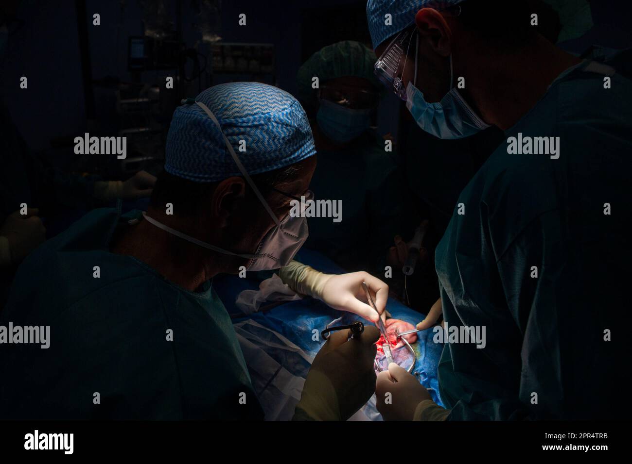 Medical doctors place an cochlear implant in a deaf person which will ...